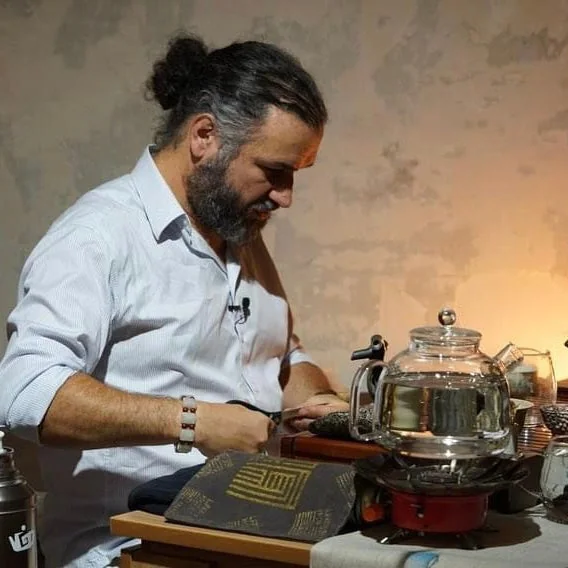 Sergey Shevelev preparing tea beside a glass kettle