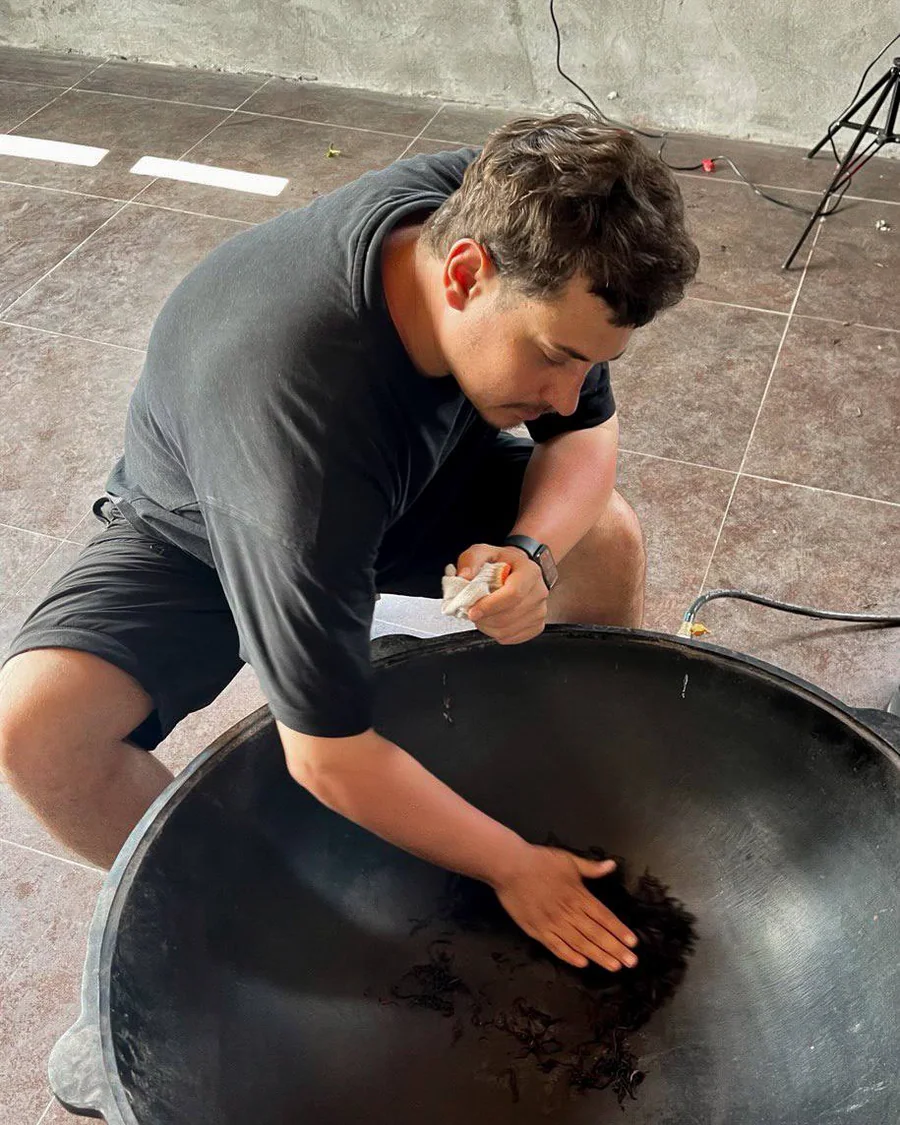 Tea being processed by hand in a large heated pan in Georgia