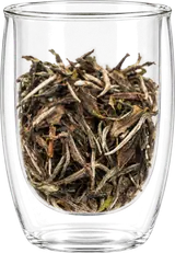 Dayong Mountain white tea: long brown-olive leaves and pale buds in a double-wall display cup