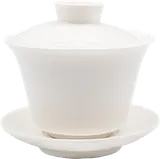 Tall white Dehua gaiwan with central lid knob and matching saucer