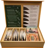 Open pu-erh tasting box with tea packets and brewing guide