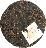 Small unwrapped Shu Long tea cake
