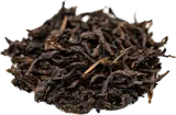 Loose, twisted dark leaves of Wild Qizhong oolong
